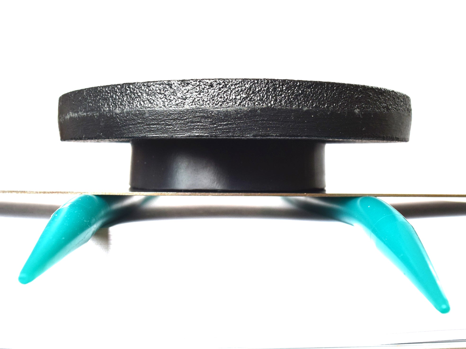 5 lb weight compression test on a teal 00-20 firmness silicone tube under a flat steel plate