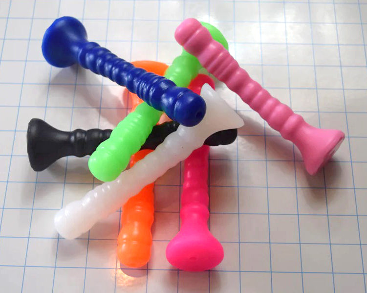 Group of Small Ribbed Shaft silicone enema nozzles arranged in an overlapping stack on a blue measurement grid background.