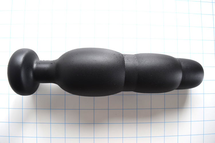 SNC MAX black silicone retention nozzle with multi-tiered expansion bulbs and a 3-inch safety flange on a grid background