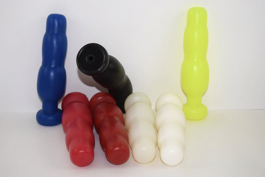 Group assortment of SNC MINI silicone retention nozzles in blue, red, dark red, white, translucent, and yellow, displaying the compact triple-bulb stepped expansion profile and flanged base.
