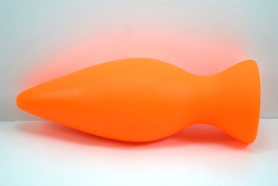 Orange silicone retention plug with a tapered tip and flanged base shown horizontally on a white background.
