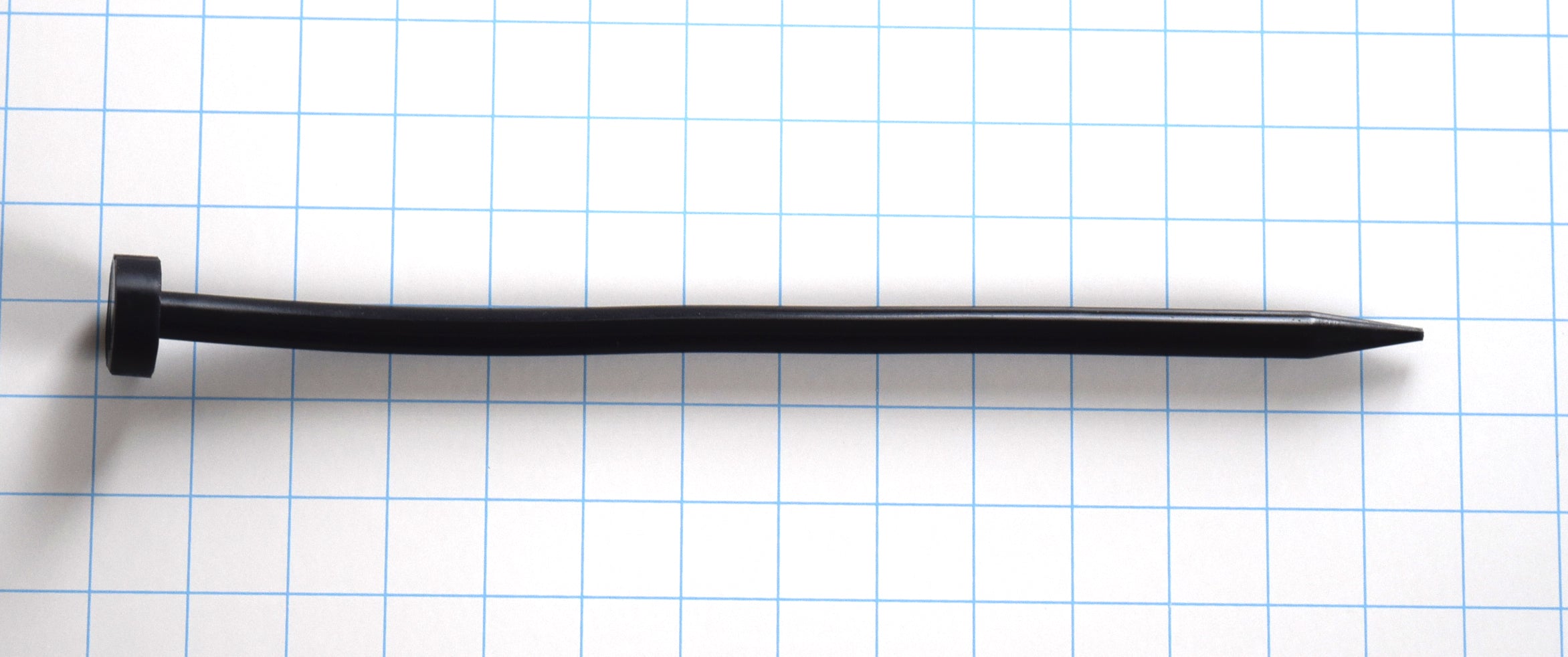 Black SPEAR-A silicone sound, 12 inches long, featuring a 12.5mm tapered spear-point tip and smooth shaft, displayed on a blue grid background.