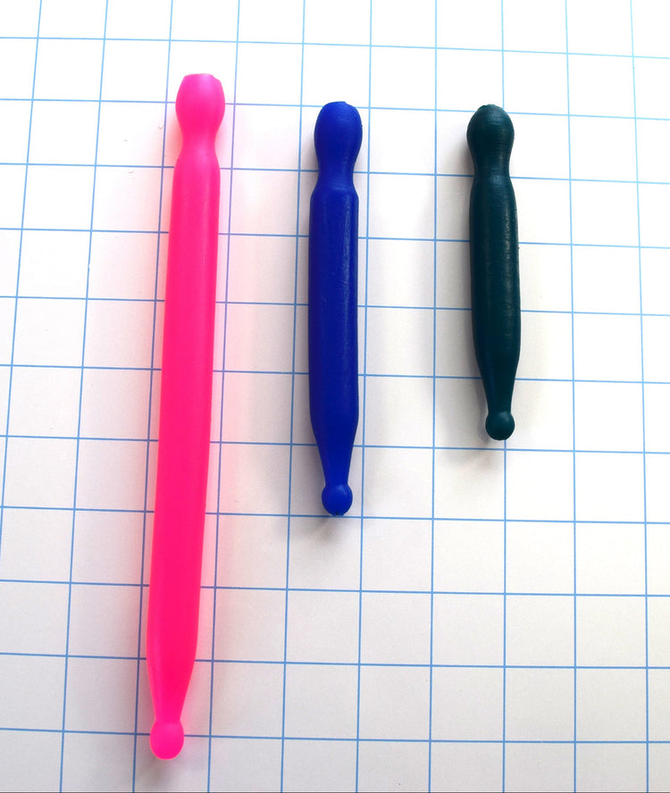 SSND-16mm retention silicone urethral sound shown horizontally on a white background with 1"x1" blue grid squares in three length options (pink, blue, and dark green), featuring a 9mm bulb tip, 16mm parallel shaft, and retention-style base groove.