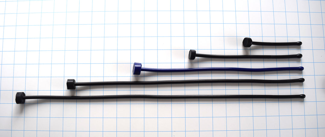 SSND-6.5BT expanded ball tip silicone urethral sounds displayed in black and blue color variants across multiple length options on a grid background, showing the 7.5mm rounded oval tips, slim 6.5mm uniform shafts, and flat safety base flanges