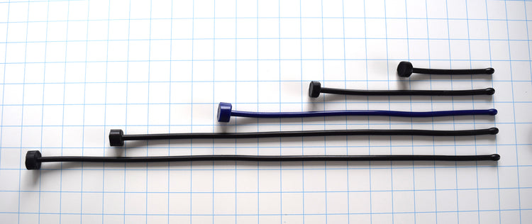 SSND-6.5BT expanded ball tip silicone urethral sounds displayed in black and blue color variants across multiple length options on a grid background, showing the 7.5mm rounded oval tips, slim 6.5mm uniform shafts, and flat safety base flanges