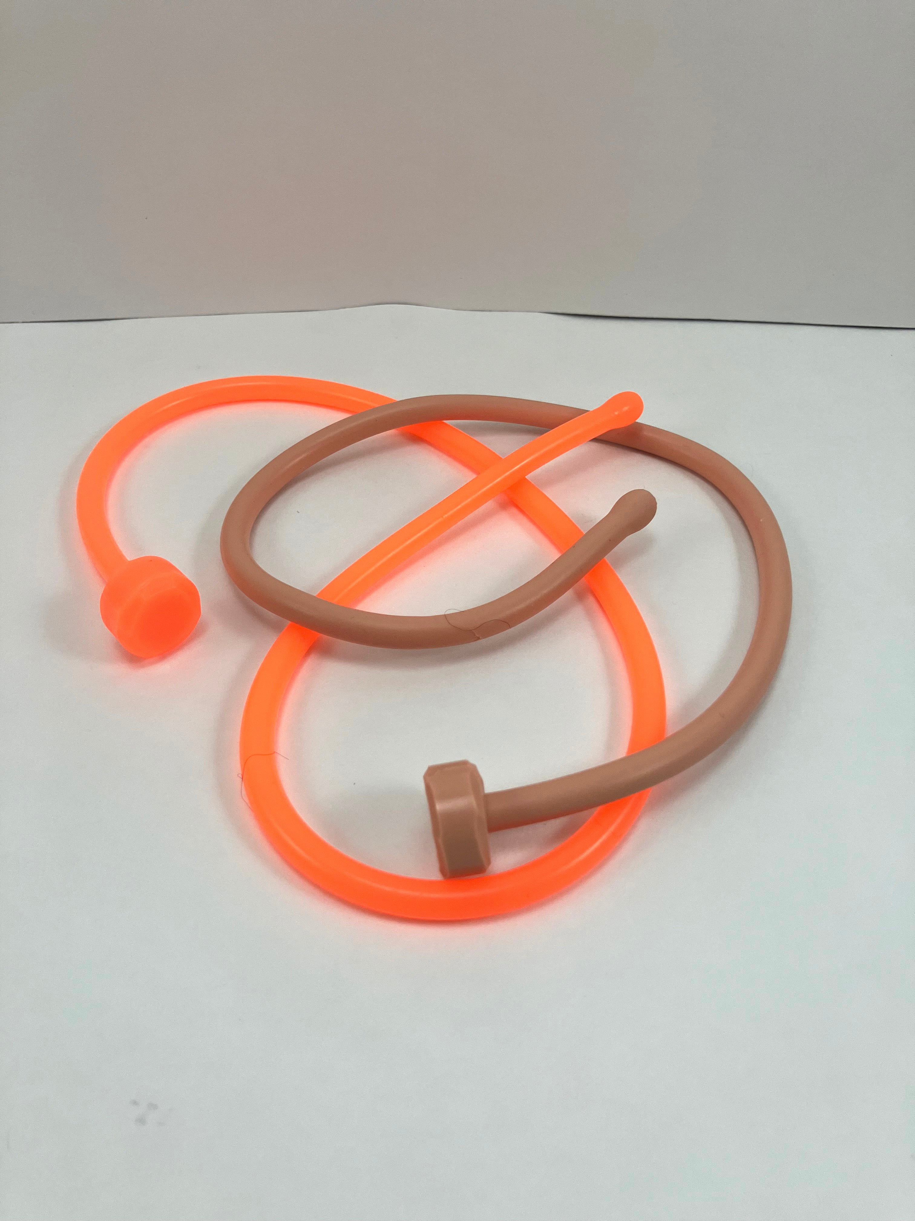 SSND-6.5BT silicone sounds shown as a pair in solid orange and translucent white mixed with standard color selections, featuring expanded ball tips, slim uniform shafts, and flat safety base flanges on a grid background.