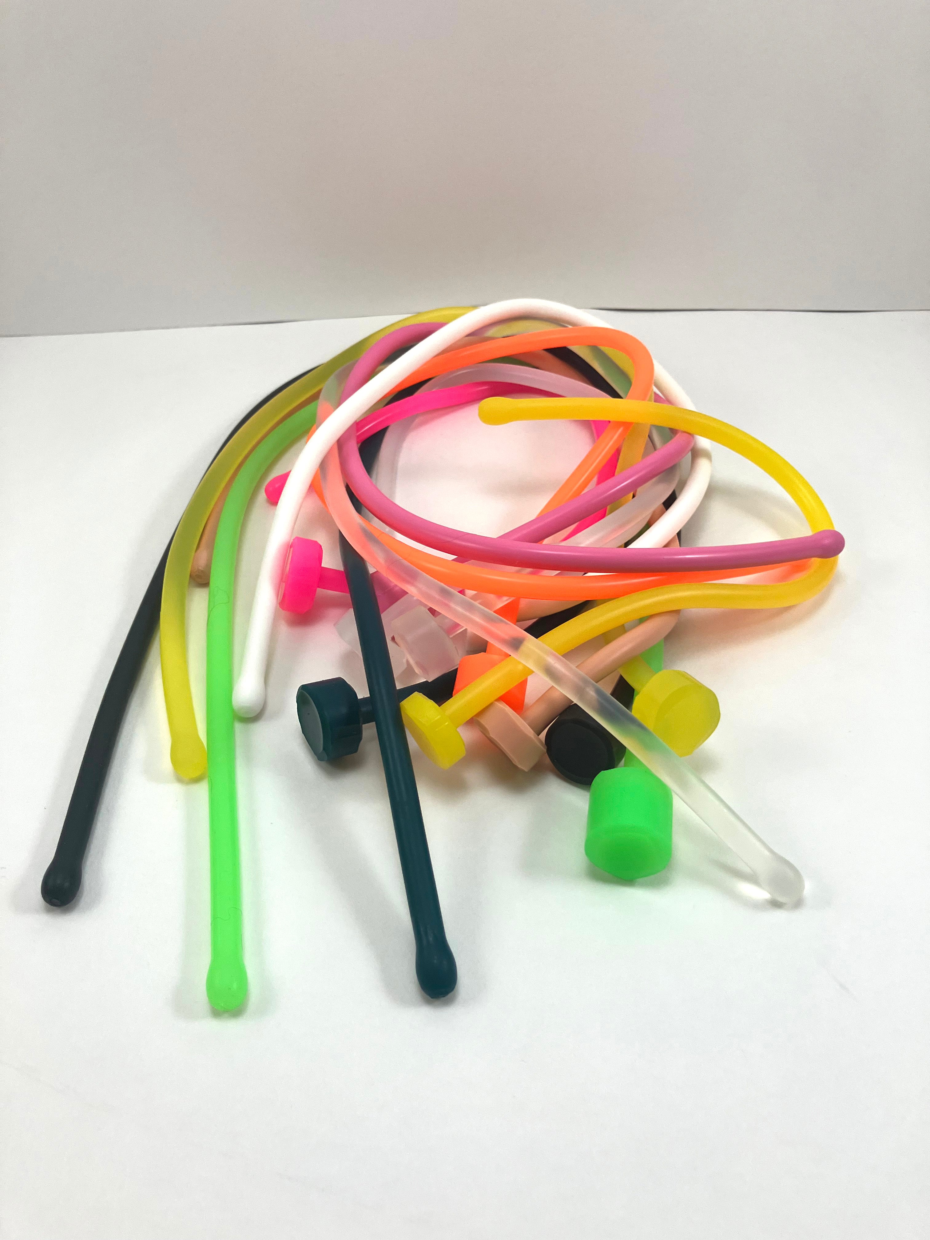 SSND-6.5BT silicone urethral sounds in translucent white and assorted translucent colors featuring 7.5mm rounded oval tips, slim 6.5mm uniform shafts, flat safety base flanges, and various length options curled together on a white background.