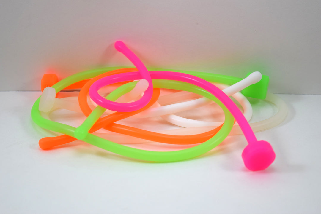 SSND-6.5BT translucent white silicone urethral sound featuring a 7.5mm rounded oval tip, slim 6.5mm uniform shaft, flat safety base flange, and solid construction on a grid background.