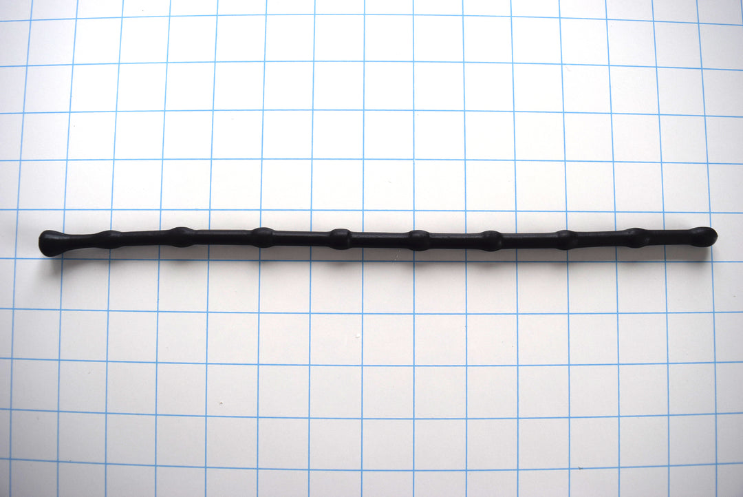 SSND-BEADBALL 330mm beaded urethral sound with 10mm ball tip and repeating 7.5mm valleys, 8 bead repetitions, 7mm retention valley, and 13.3mm safety flange on a grid background.