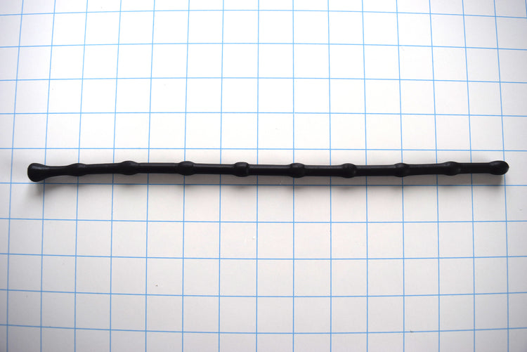 SSND-BEADBALL 330mm beaded urethral sound with 10mm ball tip and repeating 7.5mm valleys, 8 bead repetitions, 7mm retention valley, and 13.3mm safety flange on a grid background.