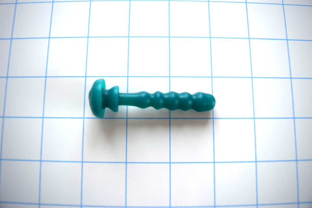 SSND-Chastity 2 silicone urethral plug and chastity insert featuring a contoured multi-ball design, open or solid core options, and dual safety flanges