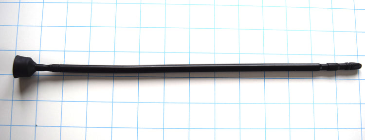 A black 13-inch contoured silicone sound with a multi-faceted tip lying horizontally across a blue grid background.