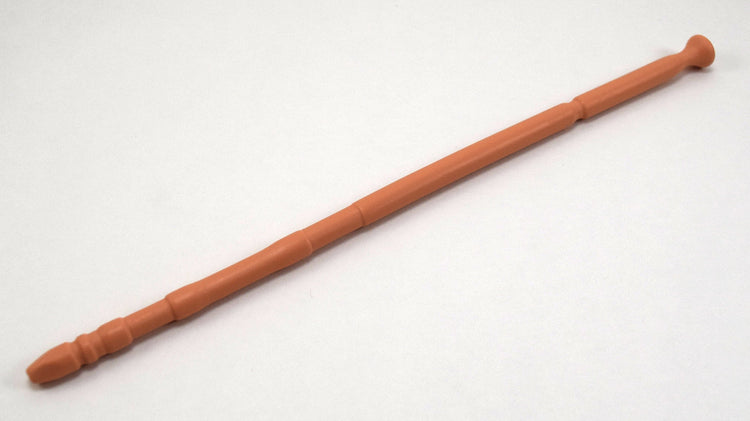 A tan flesh-tone 13-inch contoured silicone sound with a multi-faceted tip lying diagonally on a white background.