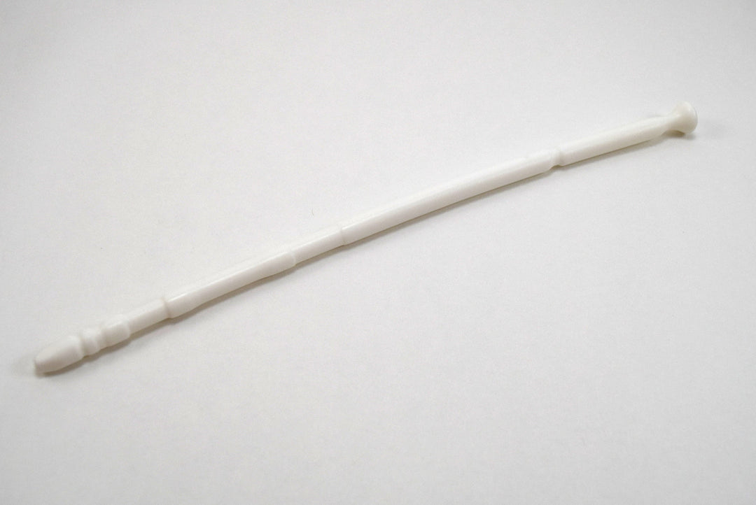A white 13-inch contoured silicone sound with a multi-faceted tip lying diagonally on a plain white surface.