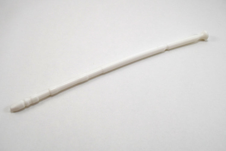 A white 13-inch contoured silicone sound with a multi-faceted tip lying diagonally on a plain white surface.