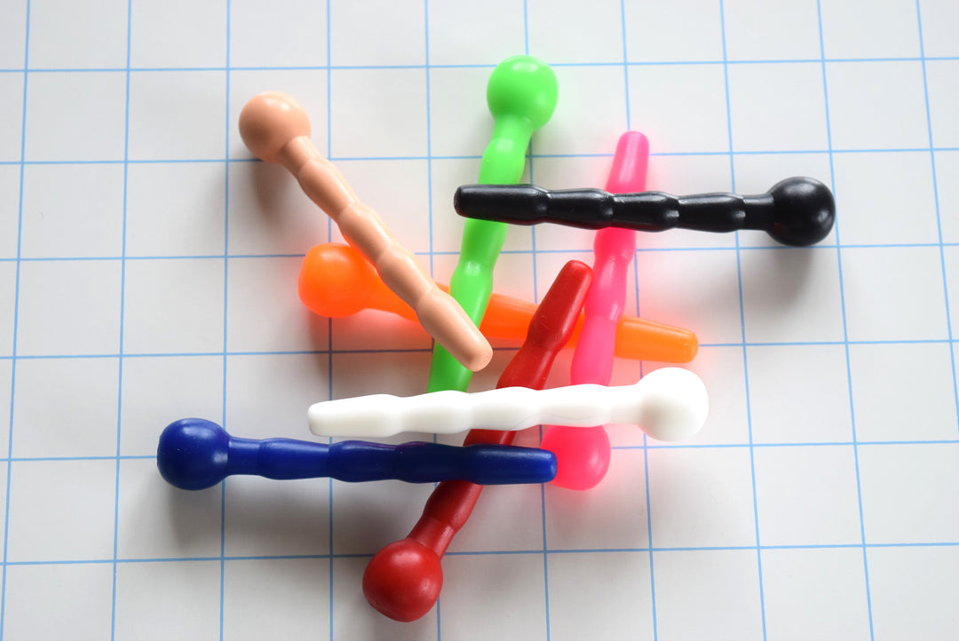 SSND-CNTRD3 short contoured silicone sounds arranged on grid background showing 7mm tip, 9.5mm swells, 8mm retention valley, and ball flange base.