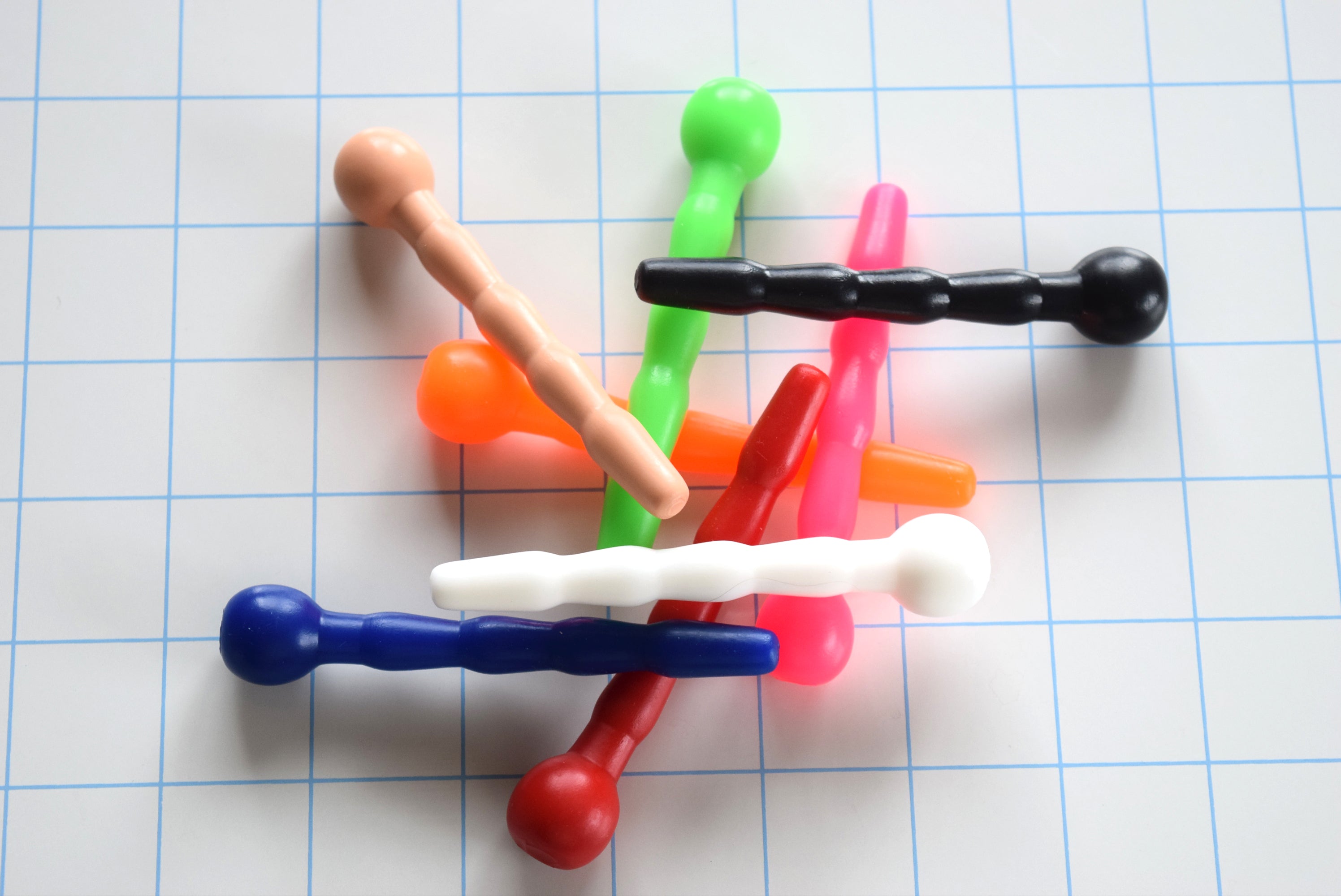 SSND-CNTRD3 short contoured silicone sounds arranged on grid background showing 7mm tip, 9.5mm swells, 8mm retention valley, and ball flange base.