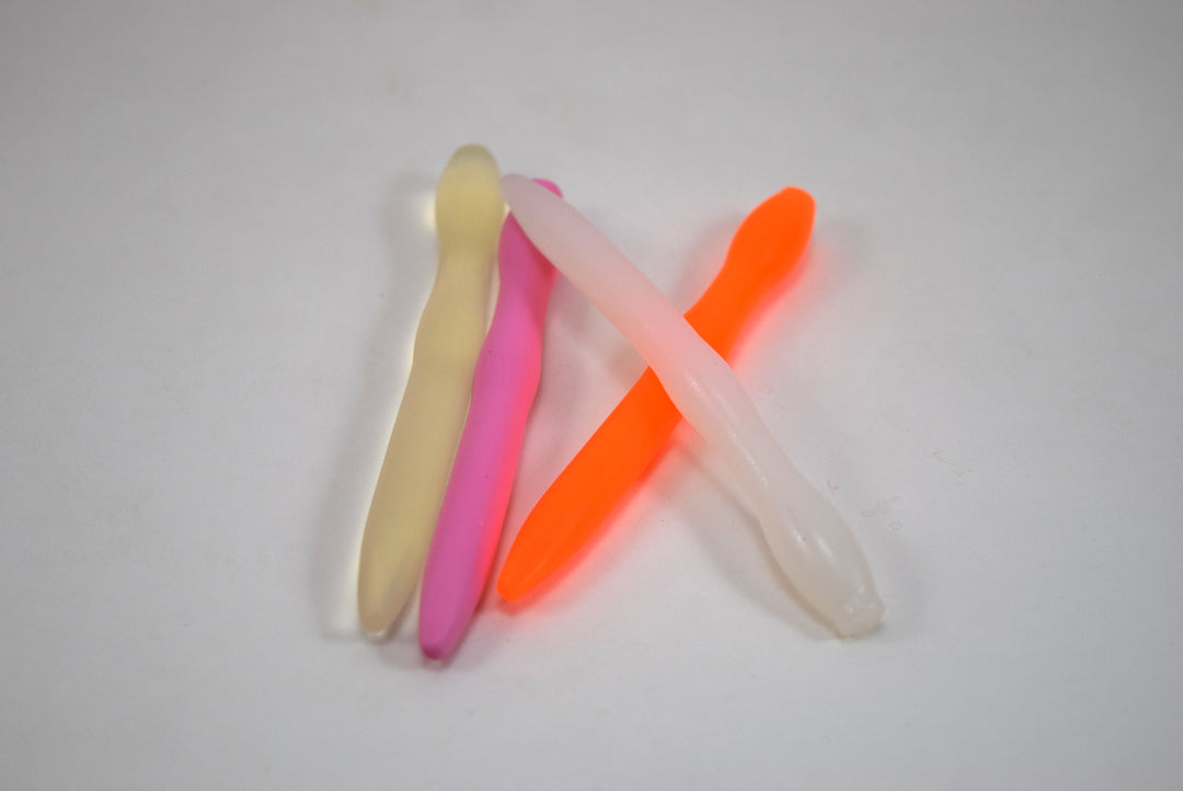 SSND-CNTRD4 short contoured silicone urethral sounds arranged in a cluster in translucent yellow, pink, neon orange, and clear variants from Screenshot 2026-07-02 132526.jpg, showing the 7mm tapered tip, 10.4mm retention ball, and 11.6mm ball flange.