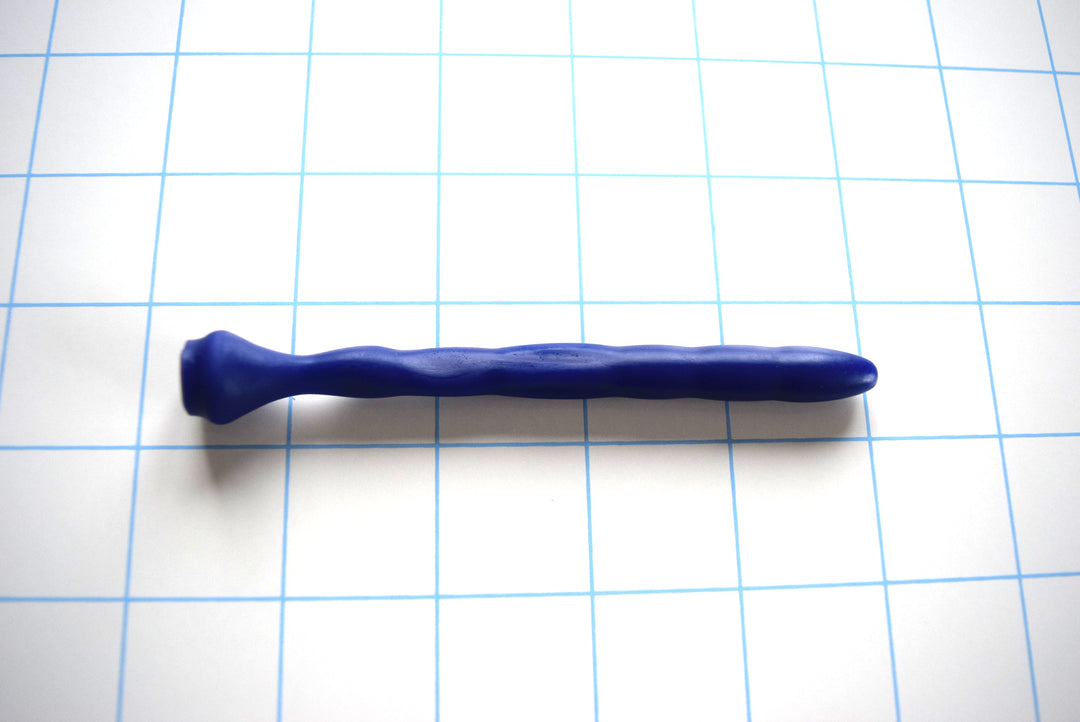 SSND-Dimpled short flexible silicone urethral sound shown in blue on a grid background, highlighting its 5mm rounded tip, 9.25mm dimpled textured shaft, and a narrow 4.75mm flattened billow section leading to a 14.5mm safety base flange.