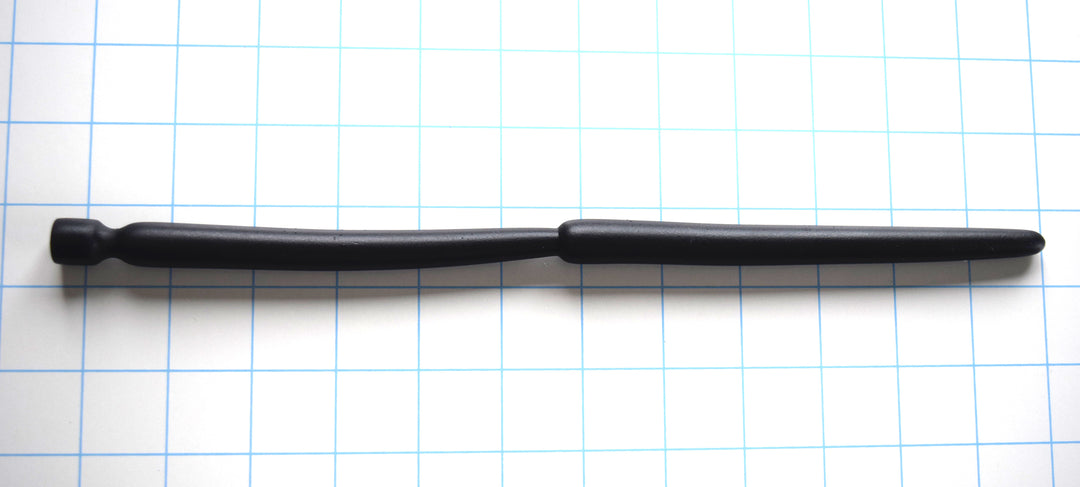 SSND-Double Expansion 12-inch advanced silicone urethral sound resting on a blue grid background, showcasing its dual 14mm and 13.7mm expansion nodes, 9mm tapered tip, and flared safety base.
