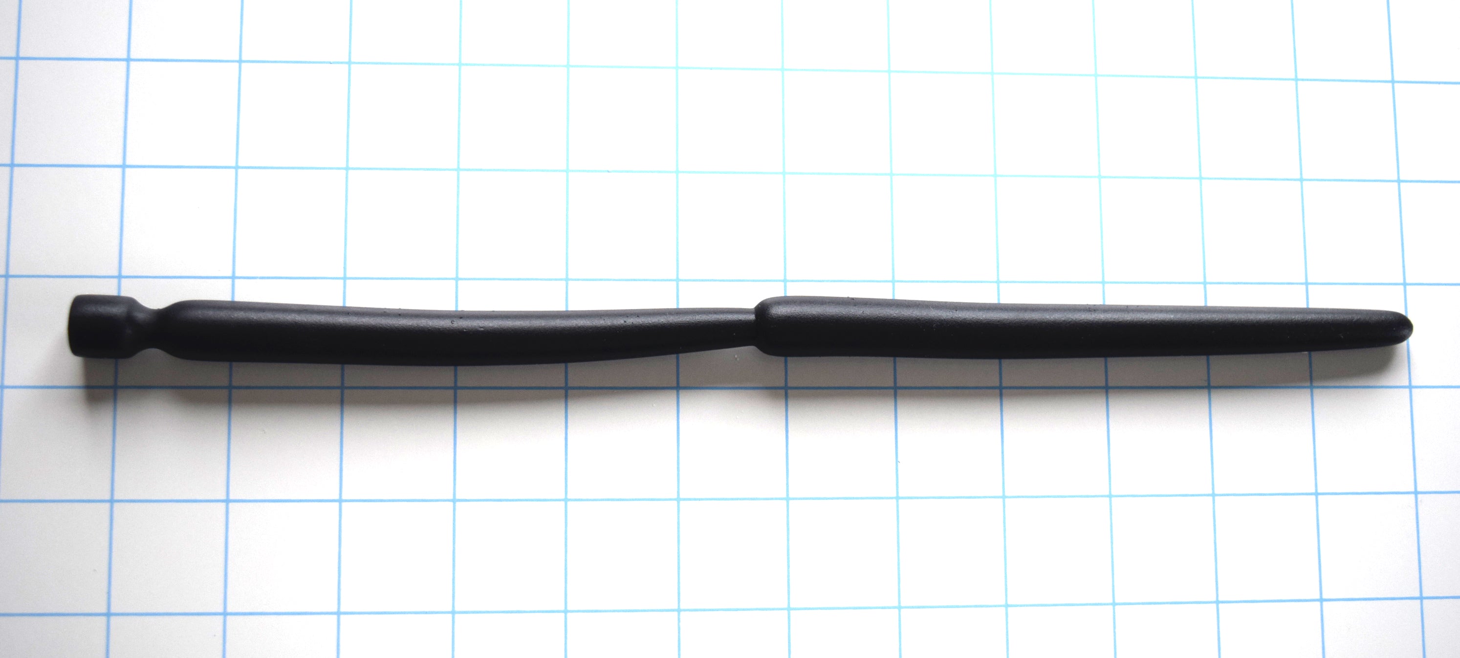 SSND-Double Expansion 12-inch advanced silicone urethral sound resting on a blue grid background, showcasing its dual 14mm and 13.7mm expansion nodes, 9mm tapered tip, and flared safety base.