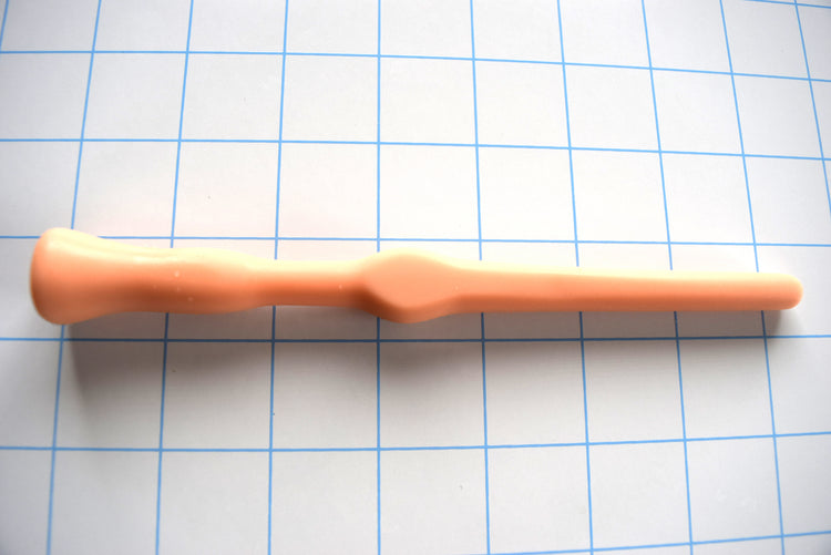 SSND-FLAT MIDBALL silicone sound in flesh tone on grid background showing tapered tip, flattened mid-ball, and retention valleys.
