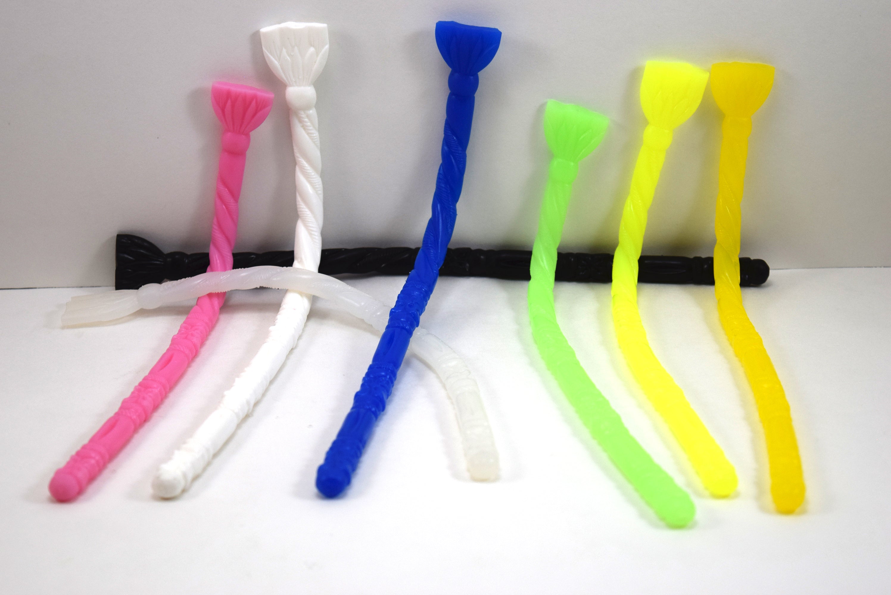 SSND-FLORENTINE10 translucent white silicone urethral sound featuring an elliptical rounded tip, alternating florettes, barrel sections, ribs, twisted rope texture, retaining ball, flat 21mm safety flange, and 9.25-inch insertable length on a grid background.