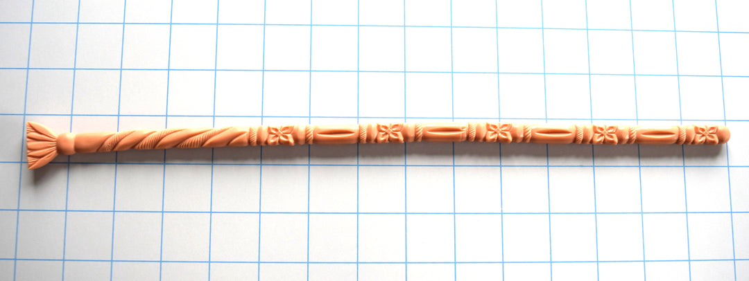 flesh-colored SSND-FLORENTINE14 silicone sound featuring intricate florets, twisted rope textures, and a flared fan-style safety base laid horizontally on a grid.