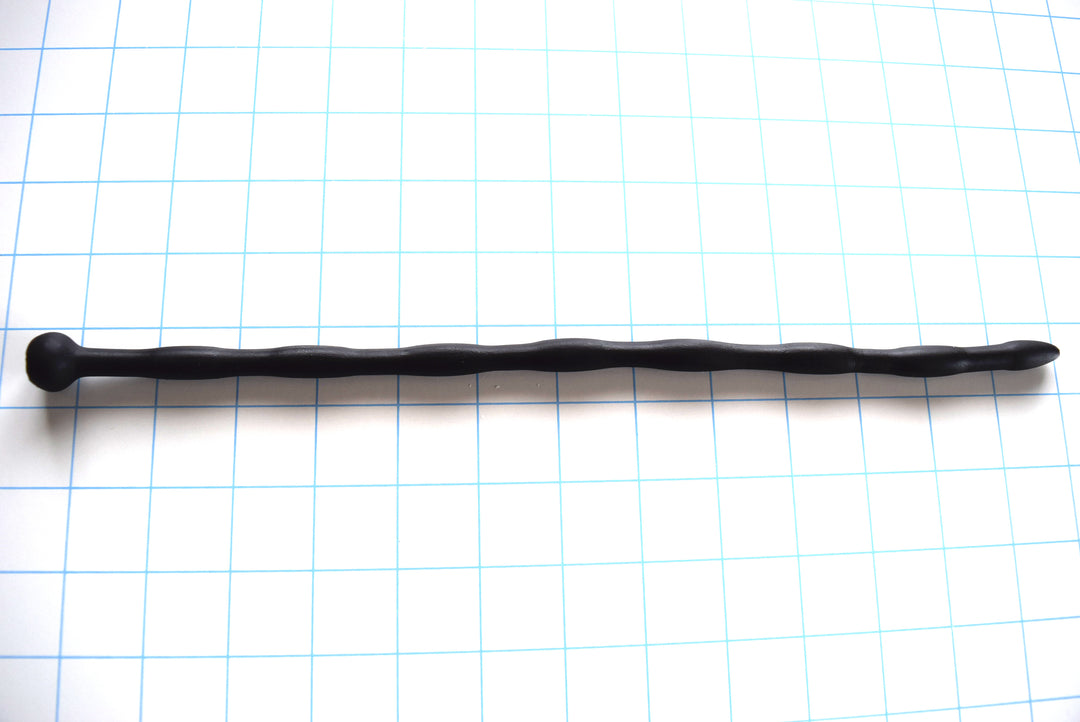 SSND-JAS4 13-inch flexible black silicone urethral sound shown horizontally on a grid background from Screenshot 2026-07-02 125743.jpg, highlighting its 10mm egg-shaped entry tip, seven repeating 10mm sensory swells, 8mm sloped valleys, and a prominent 16mm ball safety flange.