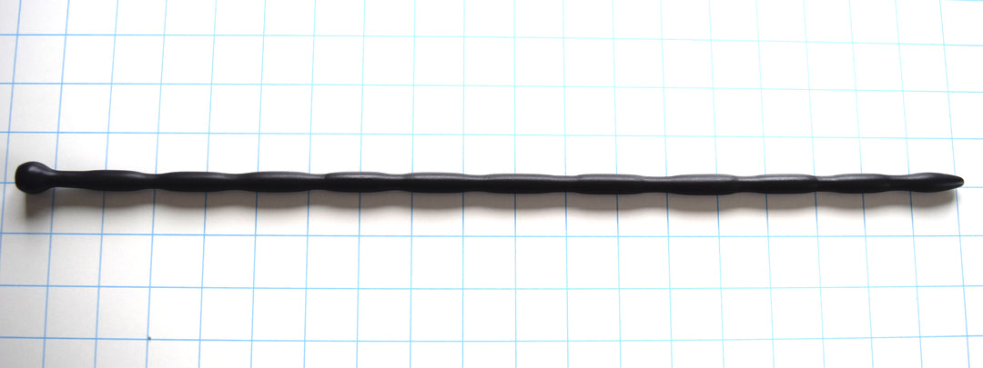 SSND-JAS4-EXTENDED 18-inch flexible black silicone urethral sound shown horizontally on a grid background from Screenshot 2026-07-02 124914.jpg, highlighting its 10mm egg-shaped entry tip, an array of repeating 10mm sensory swells, 8mm sloped valleys, and a large 16mm ball safety flange