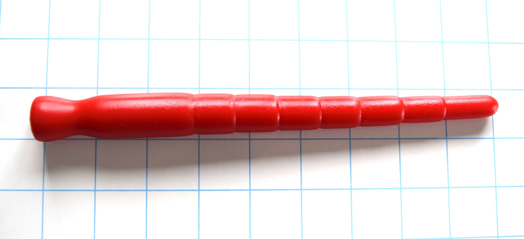 Red silicone multi-dimensional stretching sound with eight segmented ridges on a grid background.