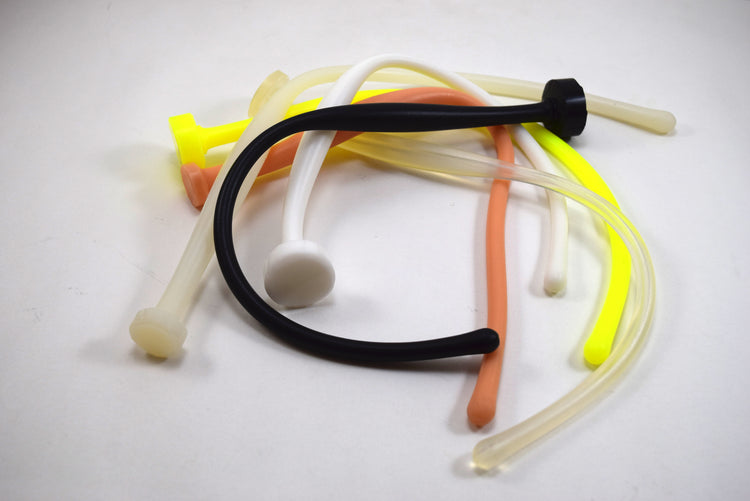 Assortment of colorful flexible SSND-MGCWAND14 silicone sounds, 14 inches long, featuring a 10.5mm rounded tip, 15mm oval expansion swell, and retention valley on a white background.