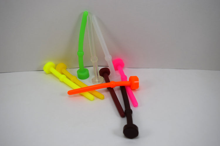 A collection of silicone urethral sounds in various colors, including green, yellow, pink, orange, and red, with rounded tips and safety flange bases.