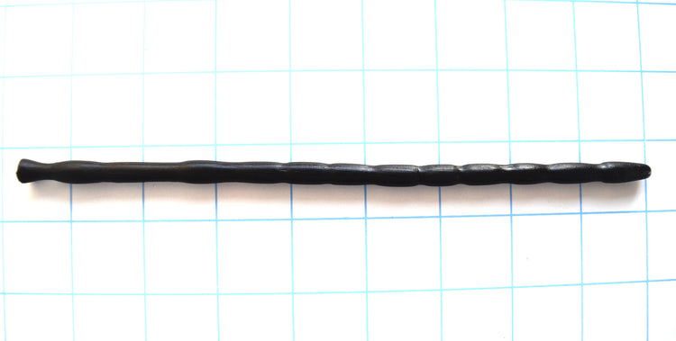 SSND-MRB 7-8mm multi-ribbed black silicone urethral sound shown horizontally on a grid background, highlighting its 10 unique texturing ribs, 9.5mm final retaining egg, 5.5mm deep retention valley groove, and flared safety base flange.