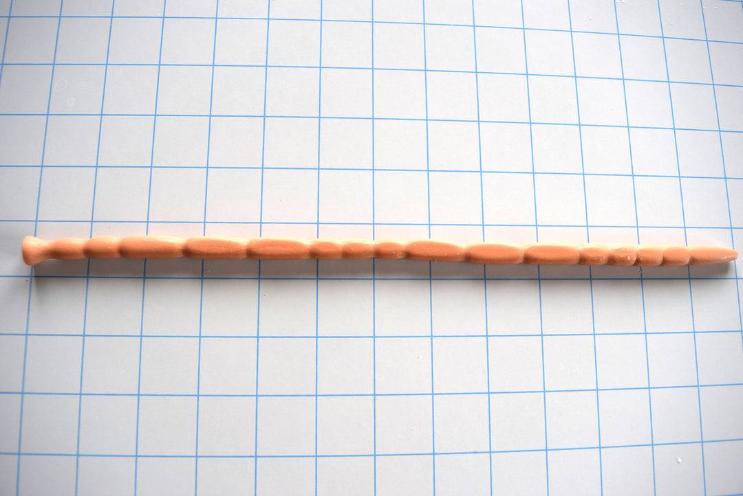 SSND-MRBCUBE multi-dimensional squared rib silicone urethral sound shown horizontally on a grid background from Screenshot 2026-07-02 104843.jpg, highlighting its 4.5mm tapered tip, 15 distinct four-sided cubed segments, 8mm relief valleys, 7mm retention groove, and flat safety base.