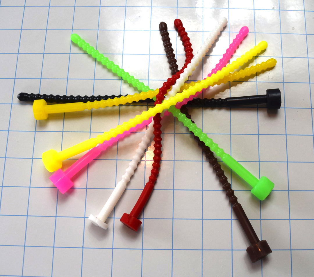 Thirteen soft, flexible SSND-RIB8 silicone urethral sounds in various colors (white, pink, yellow, green, brown, black, red) with 29 ribs and 8mm diameter, fanned out on a blue grid background.