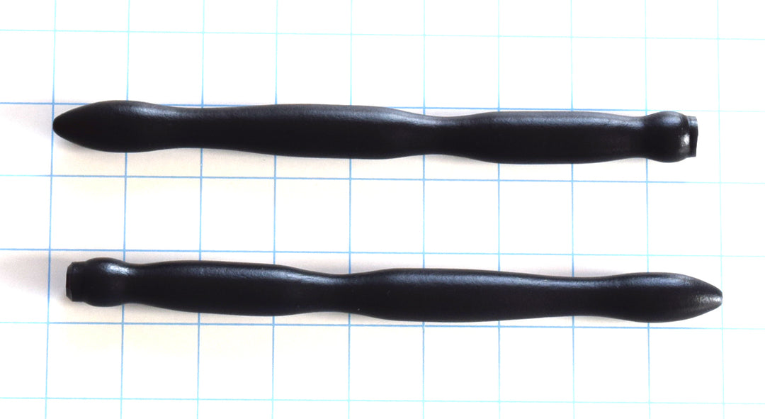 SSND-RIPPLE 6-18 black silicone urethral sound shown horizontally on a grid background, highlighting the three massive expanding wave ripples peaking at 18mm, 8-inch insertable length, and safety flared base.