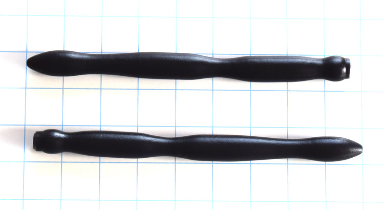 SSND-RIPPLE 6-18 black silicone urethral sound shown horizontally on a grid background, highlighting the three massive expanding wave ripples peaking at 18mm, 8-inch insertable length, and safety flared base.