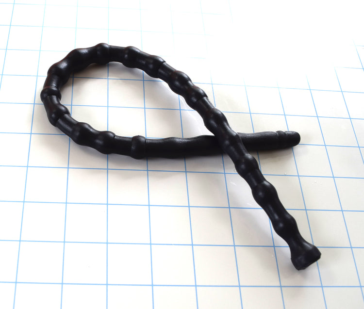 SSND-RNDMBALL 10-13 advanced black silicone urethral sound shown looped on a white background with 1"x1" blue grid squares from Screenshot 2026-07-02 152626.jpg, showcasing its flexible 22-node shifting column, 13.3mm maximum peak segments, and flared safety base flange