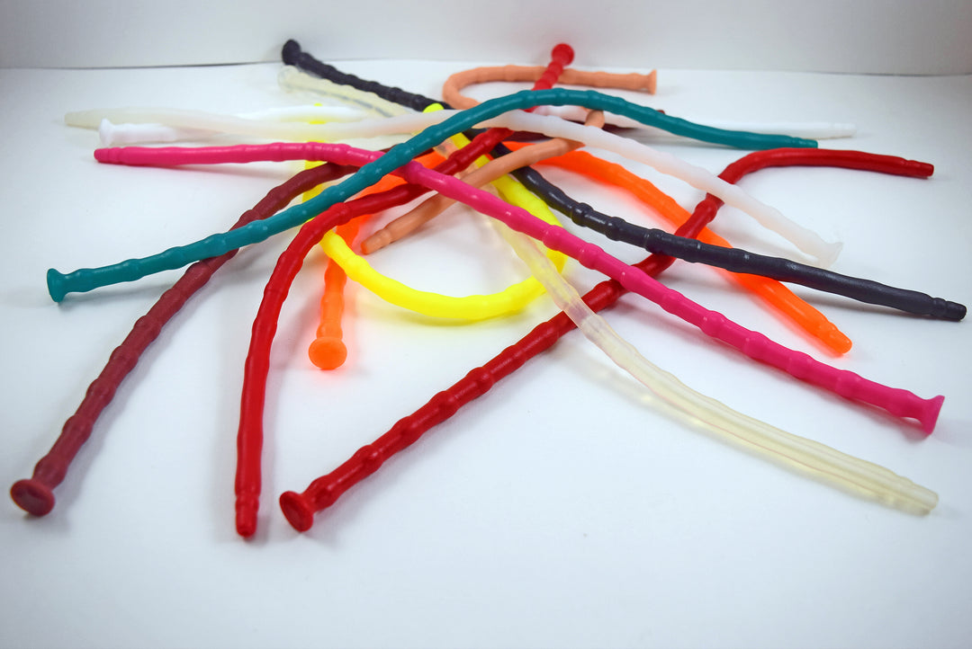 A large pile of SSND-RNDMBALL 7-10mm ribbed silicone sounds displayed in an assortment of vibrant colors including teal, red, yellow, pink, orange, and clear.