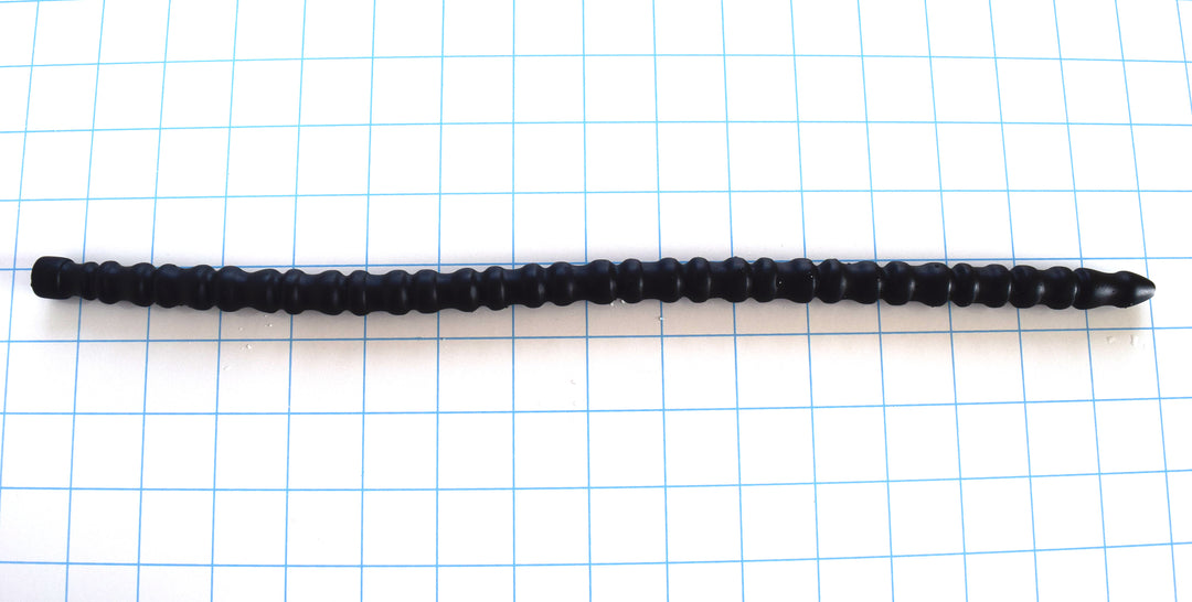 SSND-RNDMRIB expanded random ball silicone urethral sound featuring 33 alternating ribbed sections measuring 14.5 to 15.5mm, a 10mm tapered entry tip, an 11mm retention valley, and a 15-inch insertable length on a blue grid background.