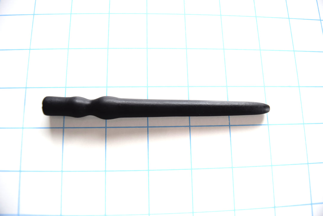 SSND-SHRTCATH 5 7 14 advanced flangeless black silicone urethral sound plug shown horizontally on a grid background from Screenshot 2026-07-02 104204.jpg, highlighting its 6mm to 12mm tapered shaft, prominent 14mm retention ball, 9mm sphincter valley, and final 12mm flangeless grip swell