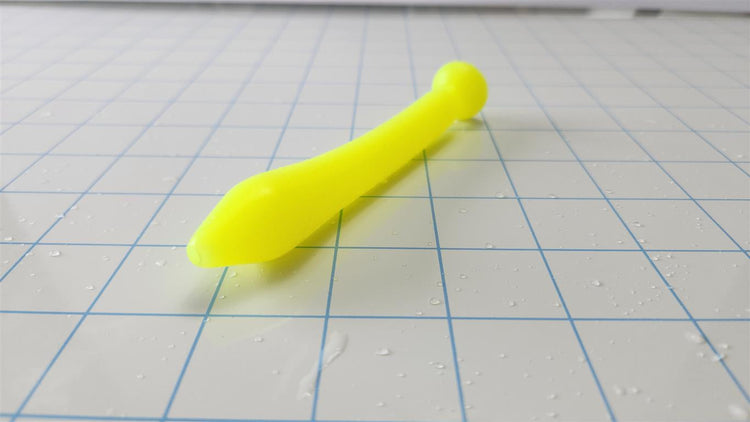Pair of SSND-Slug fluorescent yellow silicone urethral sounds featuring 5.8mm tapered tips, 20mm main bulbs, 14.5mm shafts, 10.5mm retention valleys, 22.1mm safety flanges, and 4.5-inch insertable lengths on a grid background.