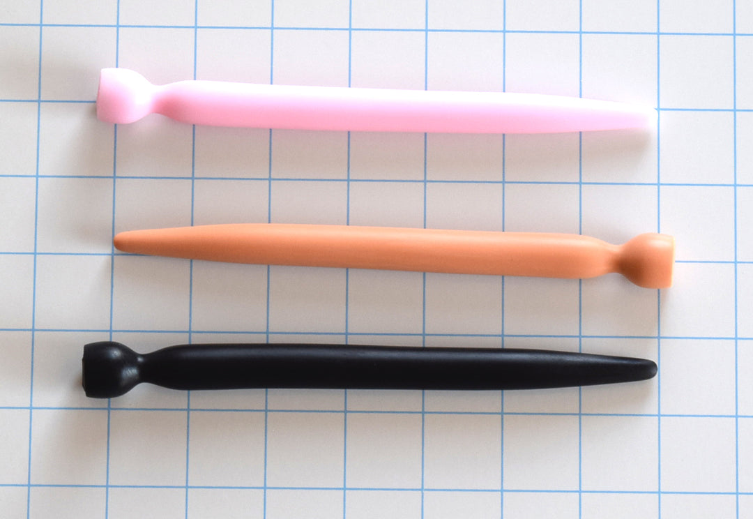 SSND-SMTPR 14.5mm gradual taper silicone urethral sound shown in pink, flesh, and black variants on a grid background, highlighting the 7mm to 14.5mm continuous stretch shaft and retention valley flange.
