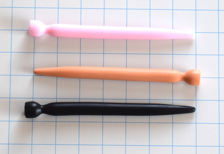 SSND-SMTPR 14.5mm gradual taper silicone urethral sound shown in pink, flesh, and black variants on a grid background, highlighting the 7mm to 14.5mm continuous stretch shaft and retention valley flange.