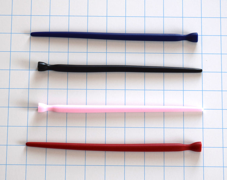 SSND-SMTPR-5-10 tapered silicone urethral sound shown in blue, black, pink, and red variants on a grid background, highlighting the gradual 5mm to 10mm expansion shaft and retention valley flange.