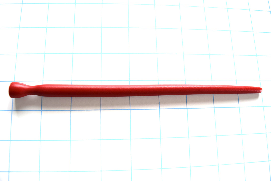 SSND-SMTPR-5-10 smooth elongated red silicone urethral sound shown horizontally on a grid background, displaying its gradual 5mm to 10mm taper, 7mm retention valley, and 12.5mm flared safety base.