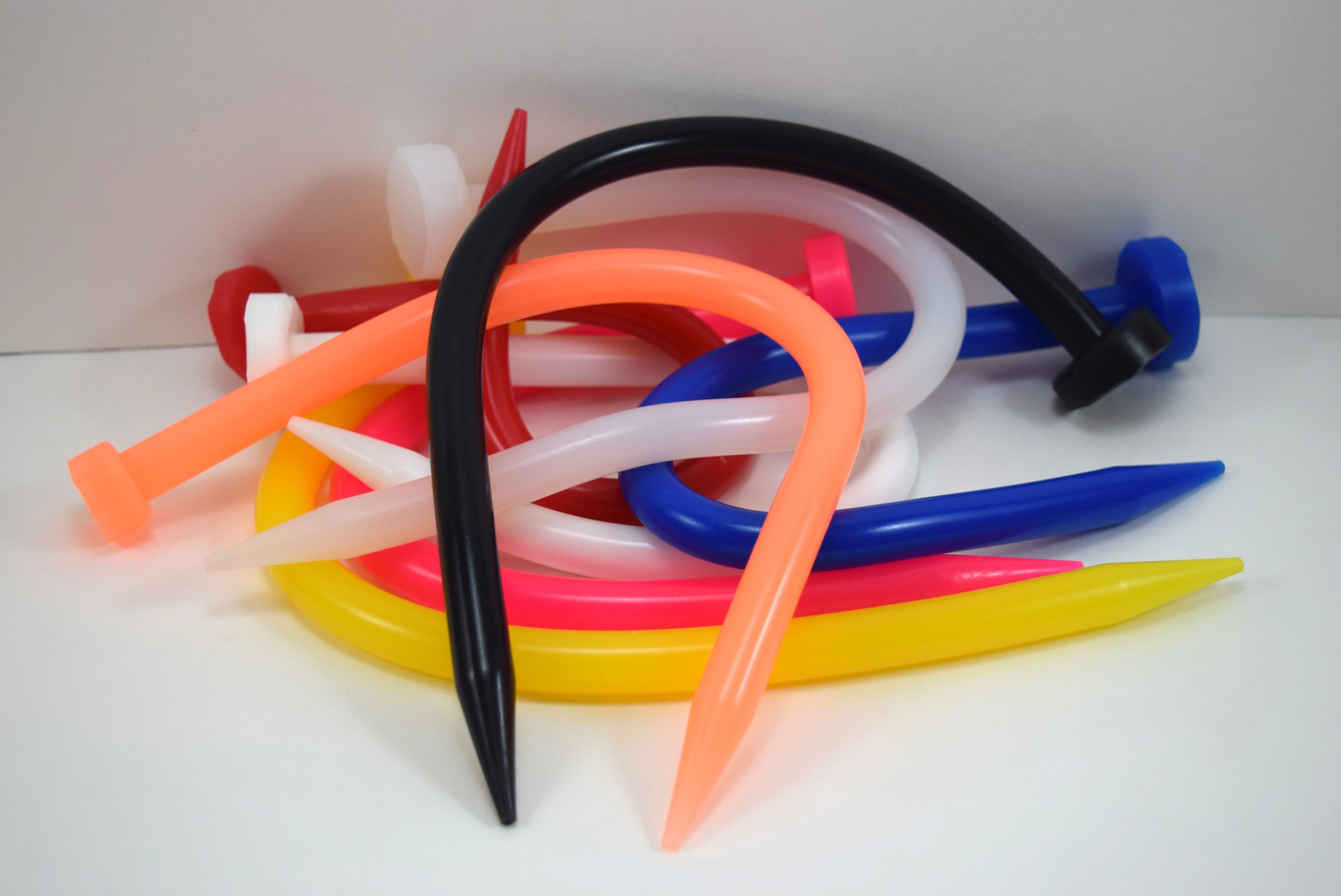 SSND-SPEAR-A 12.5mm smooth silicone urethral sound featuring a 4mm tapered tip expanding over 1 inch to a spear-pointed head, 11-inch smooth shaft, and 12-inch insertable length on a grid background.