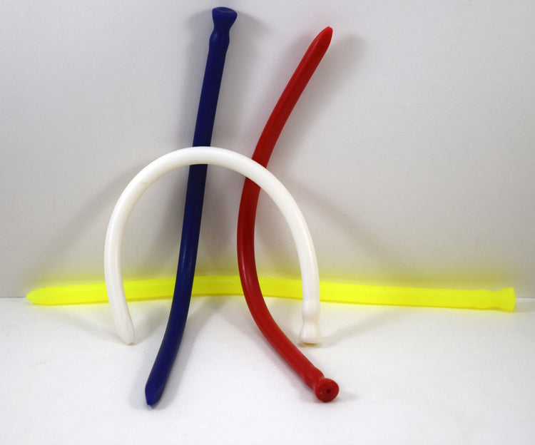 A arrangement of blue, red, white, and yellow spike-tip silicone urethral sounds on a white background.