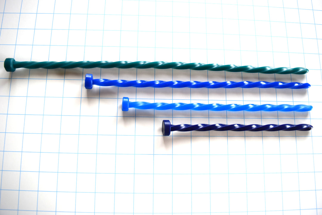 SSND-SPIRAL 10mm continuous twisted silicone urethral sounds displayed in teal, royal blue, sky blue, and dark indigo variants on a grid background, showing the rounded entry tips, four-sided 30 French helical spiral shafts, and flat safety flanges